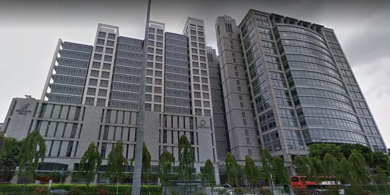 Modern office UE Square building at River Valley with tall glass and concrete facade flanked by trees